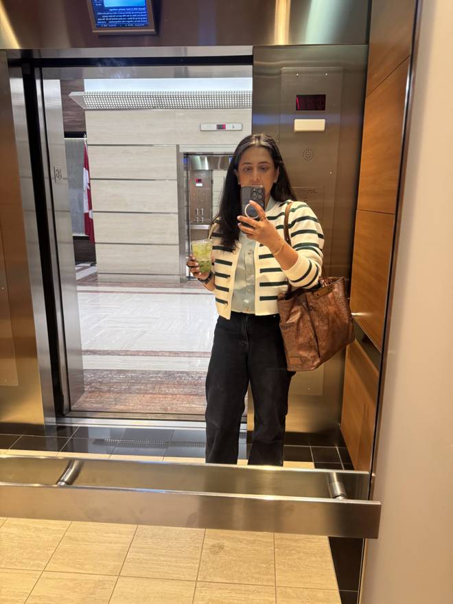 Elevator mirror selfie with a matcha in hand